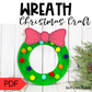 Colorful wreath craft with a pink bow on a wooden background, labeled 'Wreath Christmas Craft' and featuring a PDF icon.